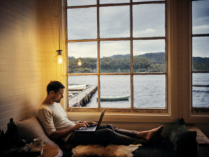 A guy using his laptop in his cozy home