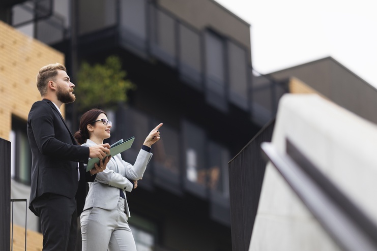 A client and a realtor pointing the condos for sale in Bethesda