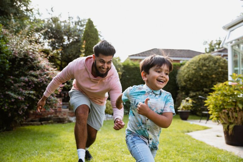 Father and Son playing in Garden - Heller Coley Reed