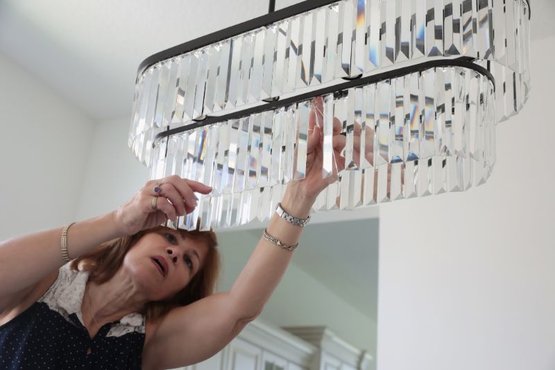 Woman fixing home lighting